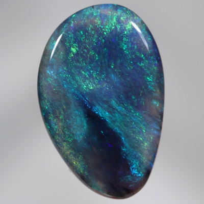 SOLID BLACK CRYSTAL OPAL Constant green and blue fire engulf a patch of black opal